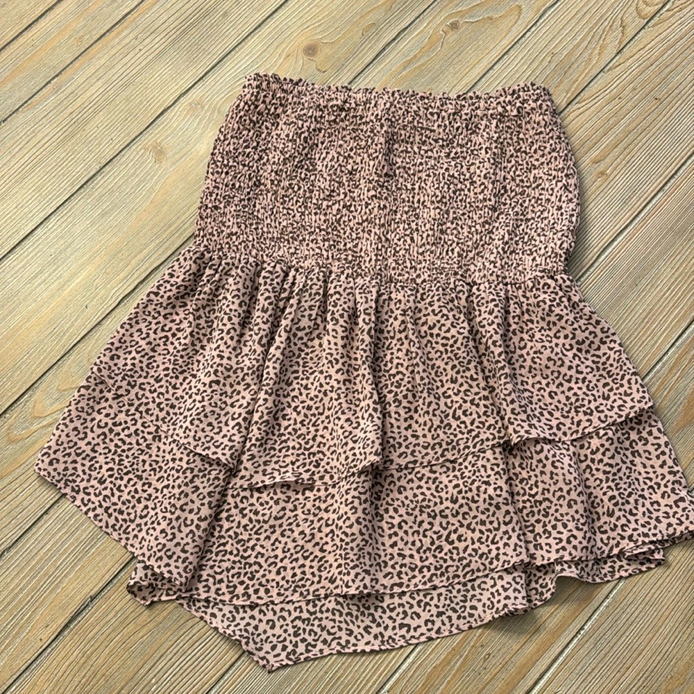 Strapless top size medium with elastic top and peplum layered ruffle bottom.